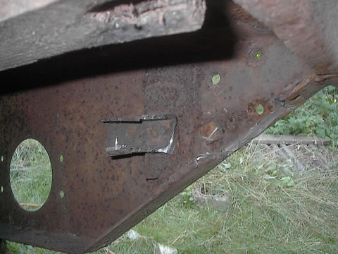 Ground/cut enough off to get the bolts out and free the left side from the rear sill.  The side panel lifts right off.  Just make sure you have all the bolts off the supports.